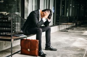 Man in suit feeling sad; possible failure